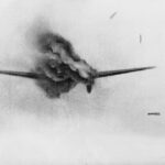 Still from gun camera film shot by Flight Lieutenant A G 'Sailor' Malan, leader of 'A' Flight, No. 74 Squadron RAF, recording his first aerial victory, a Heinkel He 111 over Dunkirk. Debris and billowing smoke. The Heinkel's starboard engine and the starboard undercarriage has dropped.